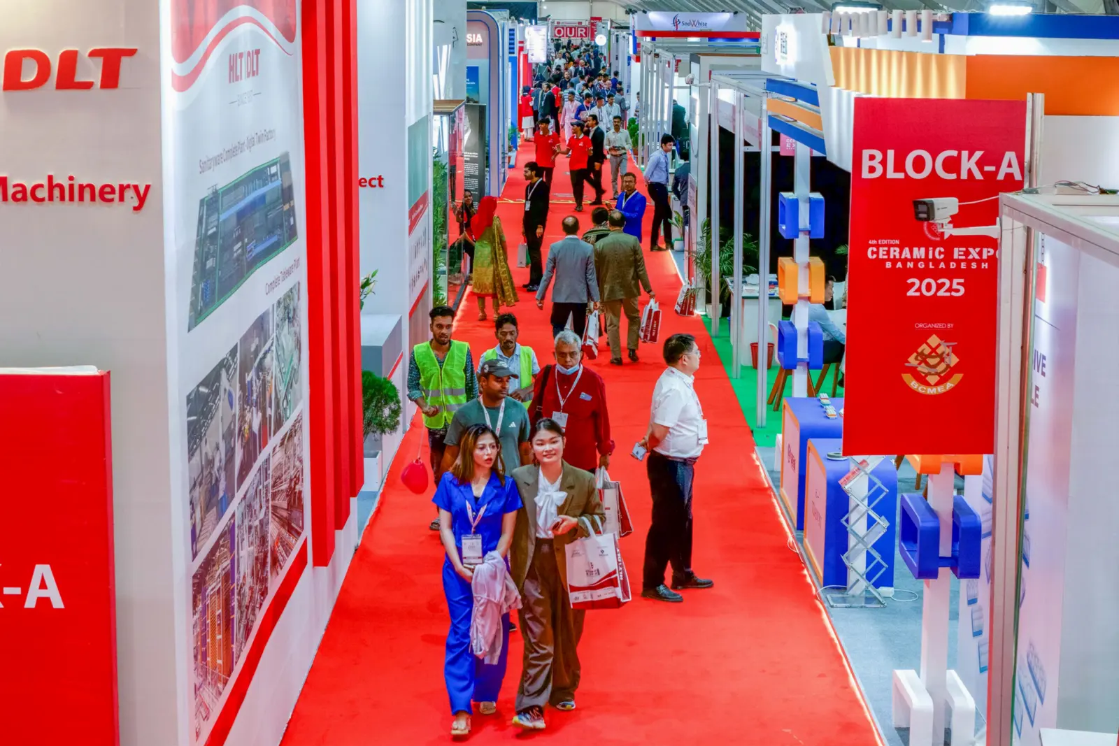 Visitors walking through the exhibitor aisles of a hygiene manufacturing exhibition